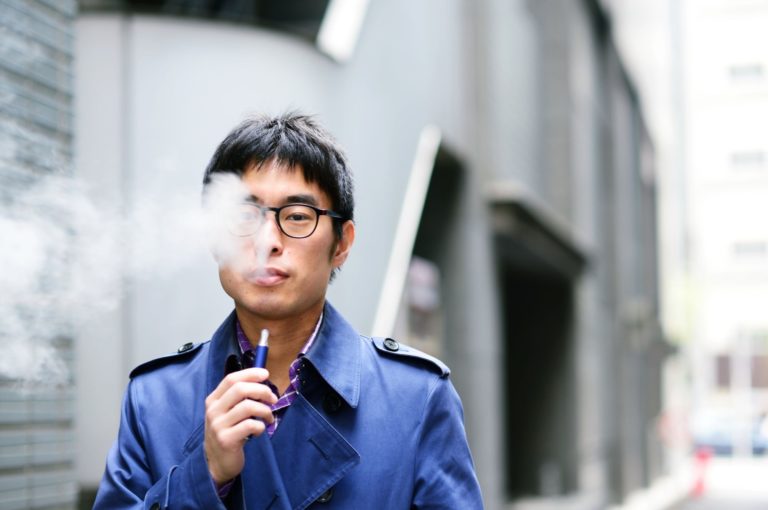 man smoking a weed pen